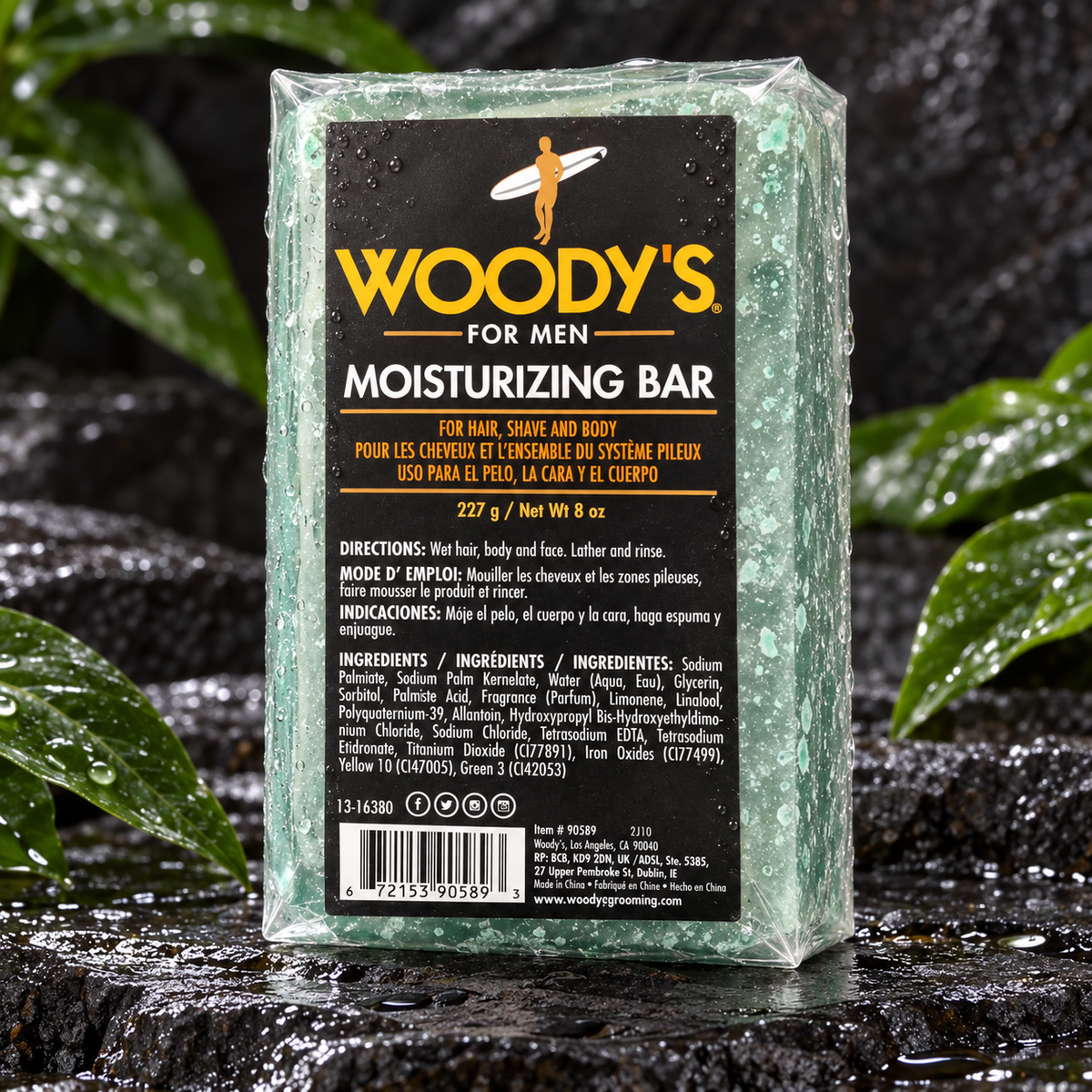 Woody's Moisturizing Bar 8 oz on wet stone with green leaves