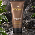 Woody's Shave Relief Balm 6 fl oz brown tube on stone with green leaves